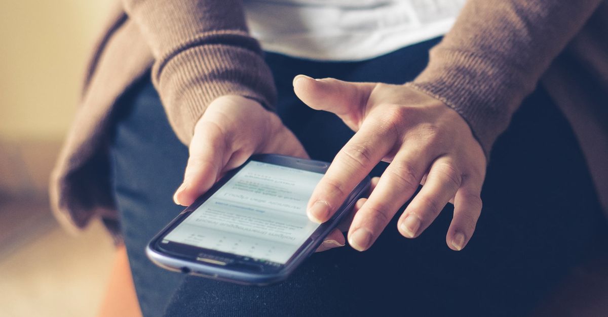 person reading FAQ on phone